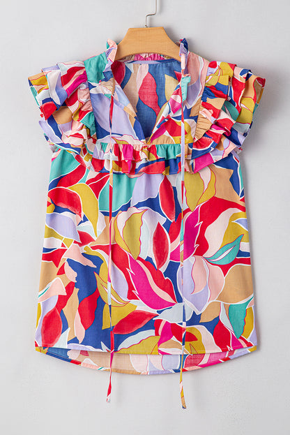 Chemisier rose à imprimé abstrait, manches volantées, col en V fendu et noué