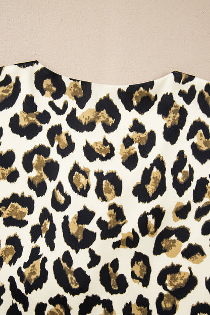 Chemisier péplum à manches bouffantes et nœud papillon sur le devant, motif léopard abricot