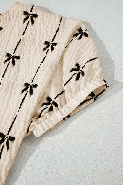 Haut à manches courtes bouffantes et imprimé nœud beige