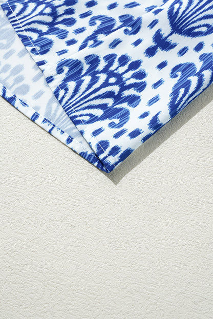 Chemisier bleu à imprimé floral et manches bouffantes avec col à volants