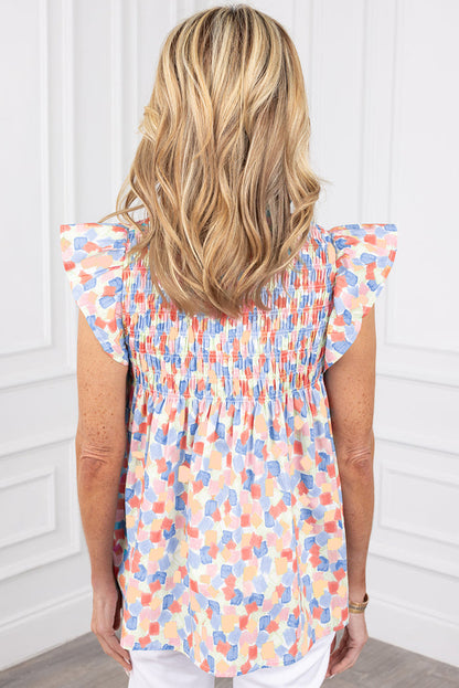 Chemisier rose à imprimé abstrait et à volants