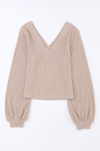 Haut noir en tricot jacquard à col en V et manches lanternes