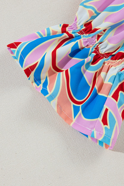 Chemisier rose à imprimé abstrait, col à volants et manches à volants