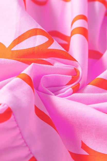 Robe grande taille à volants et taille cintrée avec nœud rose