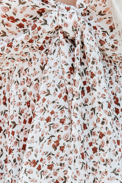 Blusa de manga larga con volantes y lazo delantero con estampado floral