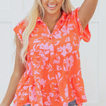 Chemisier orange à imprimé floral, col boutonné, manches flottantes