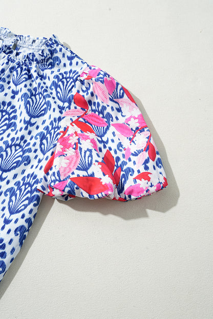 Chemisier bleu à imprimé floral et manches bouffantes avec col à volants