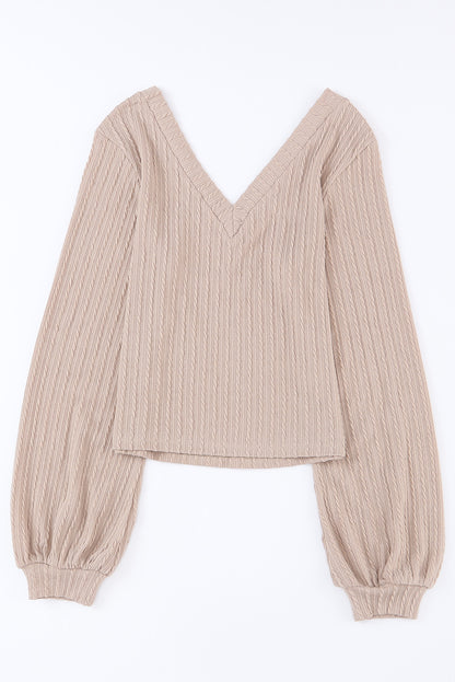 Haut noir en tricot jacquard à col en V et manches lanternes