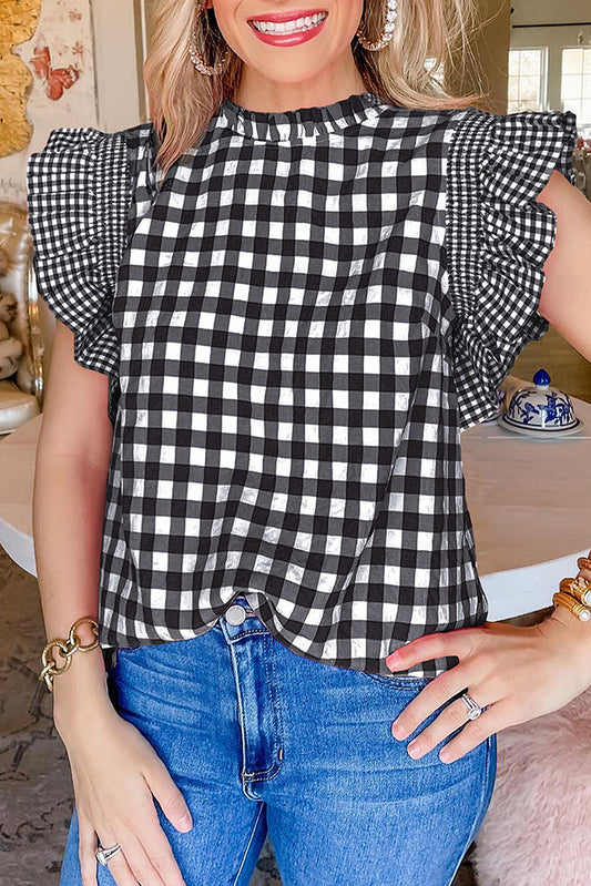 Chemisier noir à carreaux, manches volantées et col volanté