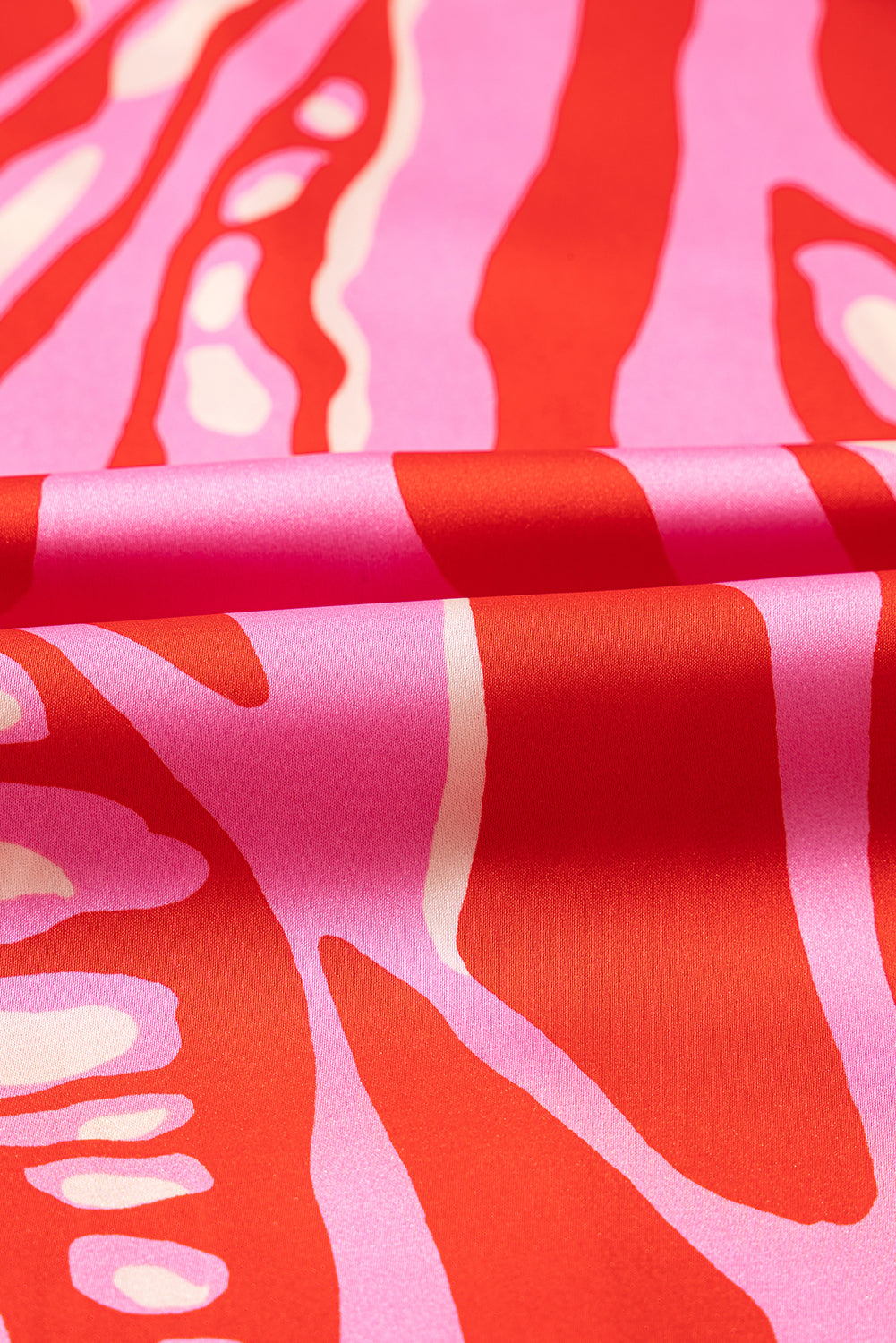 Chemisier surdimensionné rouge à imprimé abstrait, col en V et manches chauve-souris