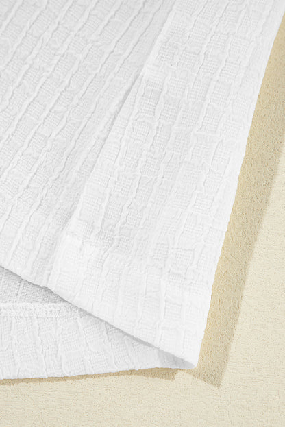 Chemisier texturé à manches bouffantes et broderie florale blanche