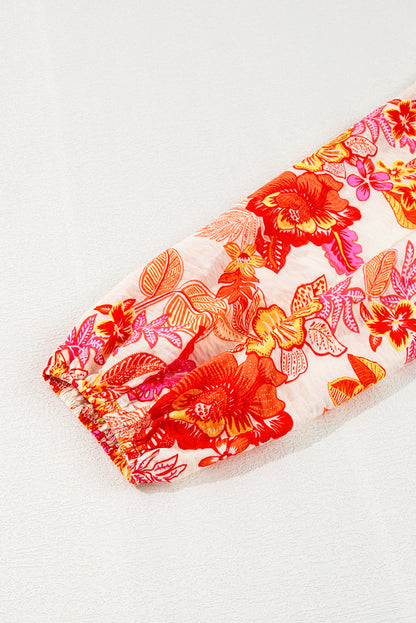 Chemisier orange à imprimé floral, boutons nacrés, manches longues bouffantes et trou de serrure