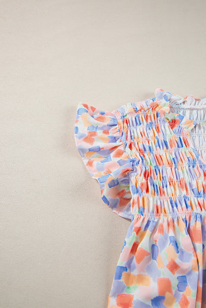 Chemisier rose à imprimé abstrait et à volants