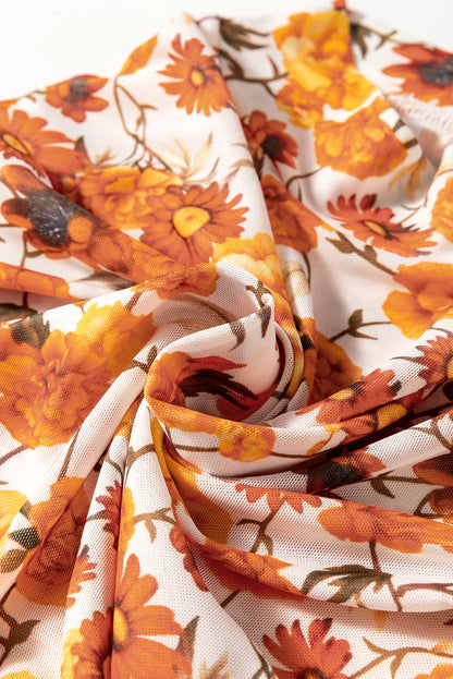 Chemisier orange à imprimé floral, manches cloche, col montant, bordure festonnée