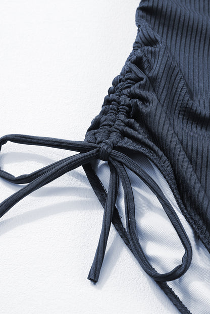 Maillot de bain une pièce bleu marine côtelé avec cordon de serrage et découpes sur les côtés