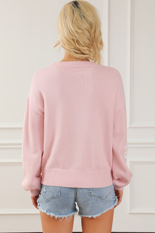 Pull ras du cou rose en chenille avec coutures marguerites 
