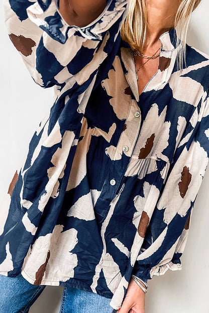 Chemisier bleu voile à imprimé floral abstrait et manches bouffantes à demi-boutons