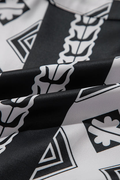 Robe noire à volants et col en V à imprimé géométrique