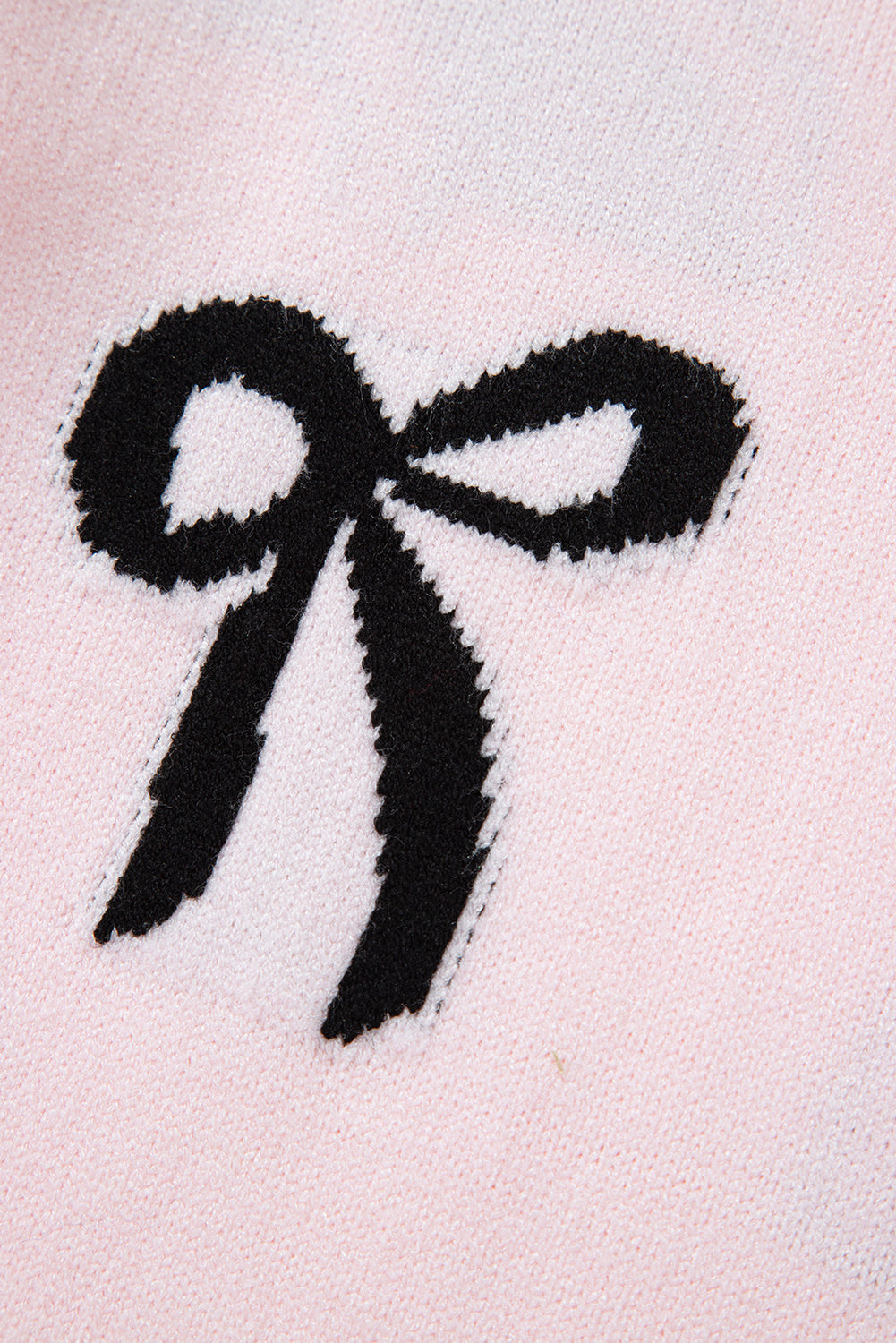 Pull ample en maille rose clair à motif nœud