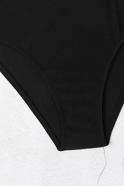 Maillot de bain une pièce noir texturé à découpes asymétriques 