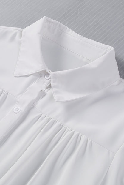 Chemisier boutonné à manches bouffantes de couleur unie