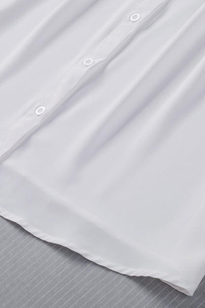 Chemisier boutonné à manches bouffantes de couleur unie