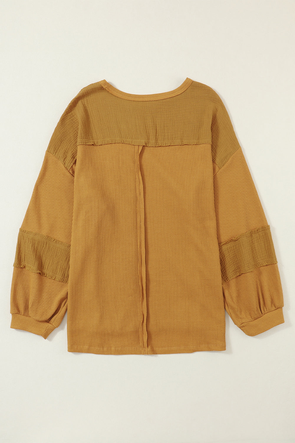 Haut en tricot gaufré à manches bouffantes et coutures apparentes