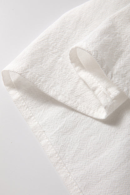 Chemisier blanc boutonné à manches longues et broderie géométrique