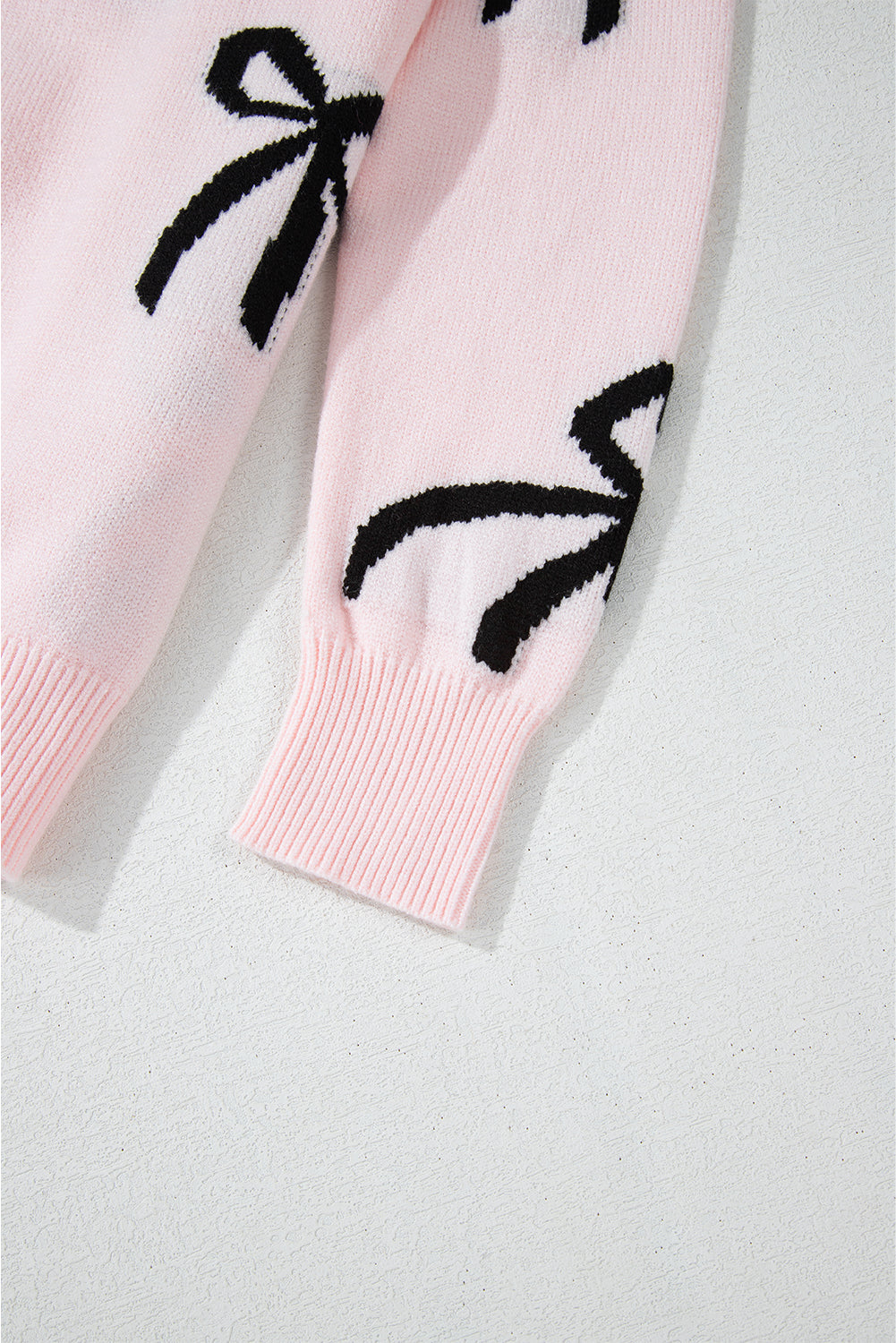 Pull ample en maille rose clair à motif nœud