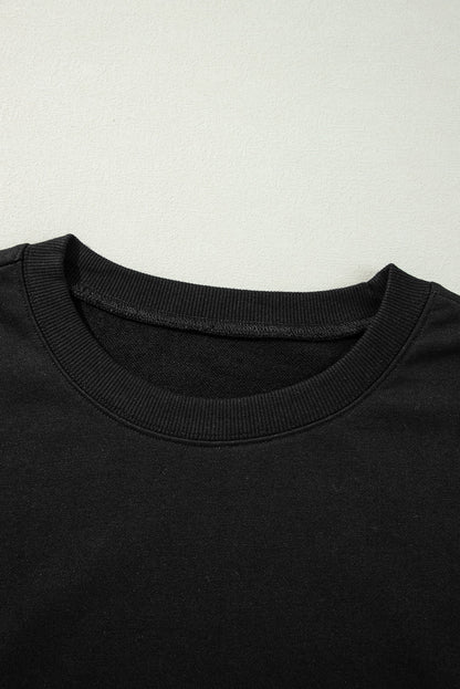 Sweat-shirt noir à col rond et épaules tombantes avec coutures apparentes et fentes