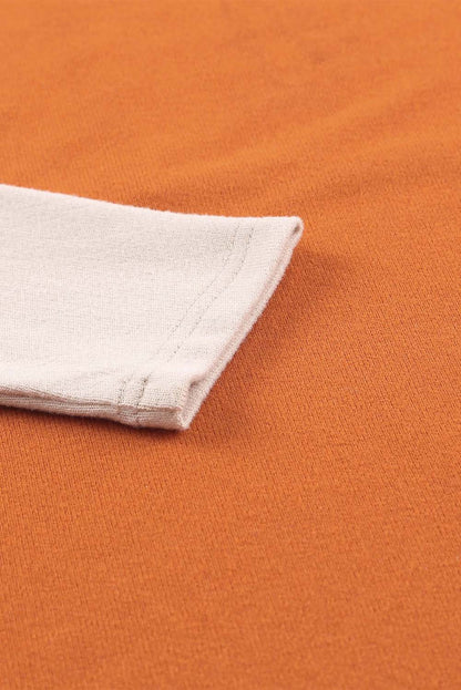 Top de manga larga con patchwork de bloques de color y bolsillos