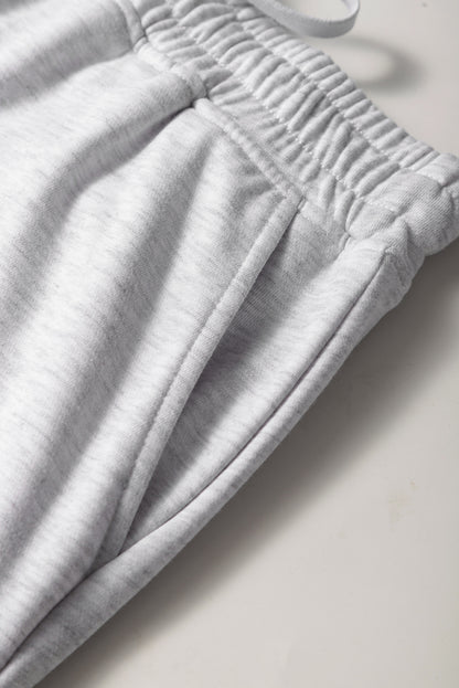 Mini-jupe en molleton gris clair avec cordon de serrage et poches