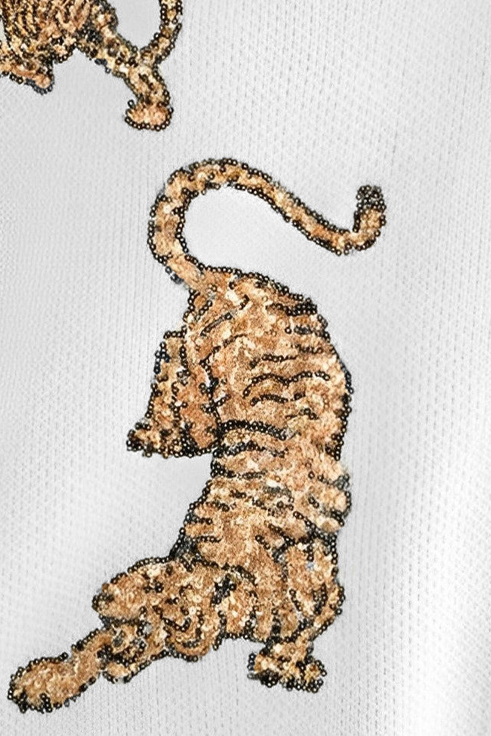 Pull tigre blanc à paillettes effilochées