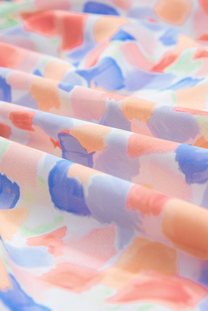 Chemisier rose à imprimé abstrait et à volants