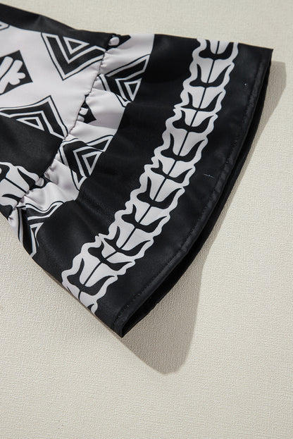 Robe noire à volants et col en V à imprimé géométrique