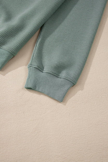 Haut à col en V et épaules tombantes en tricot gaufré Clearly Aqua