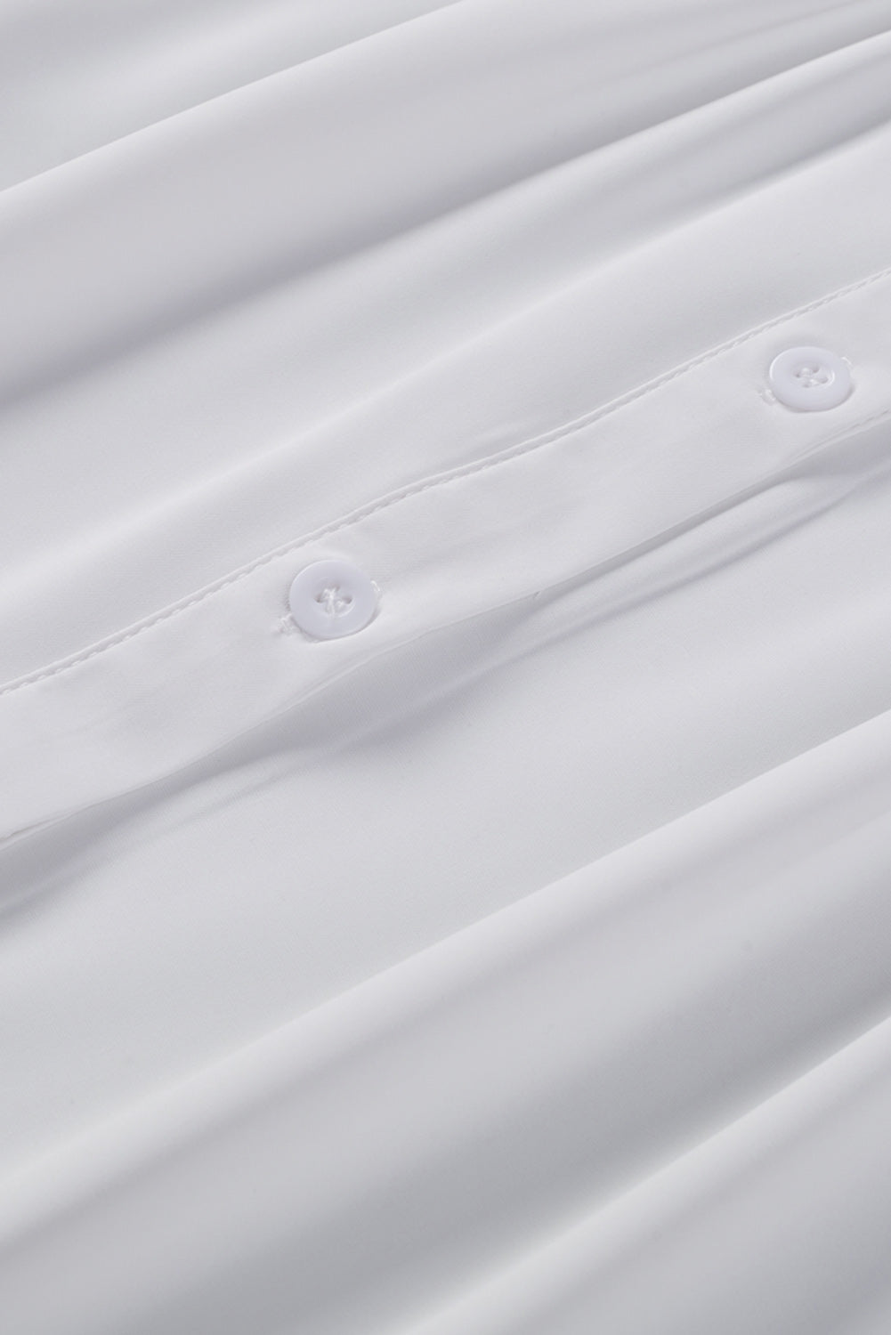 Chemisier boutonné à manches bouffantes de couleur unie