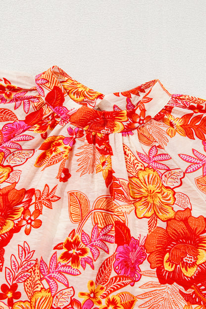 Chemisier orange à imprimé floral, boutons nacrés, manches longues bouffantes et trou de serrure