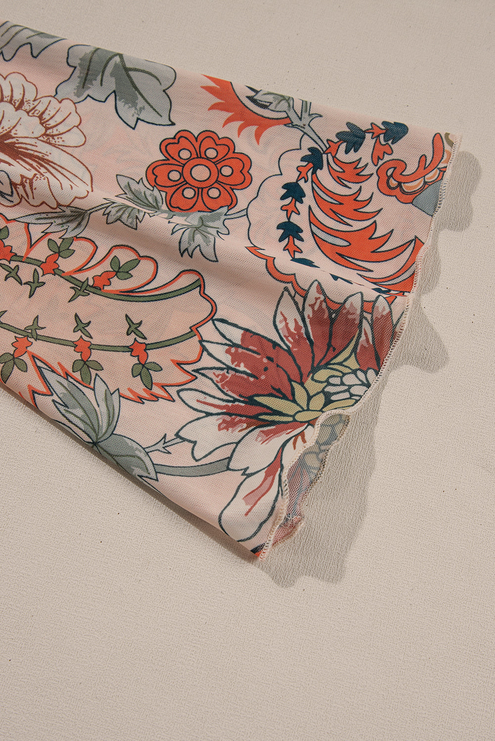 Chemisier orange à imprimé floral, col en V profond, manches cloche et nœud