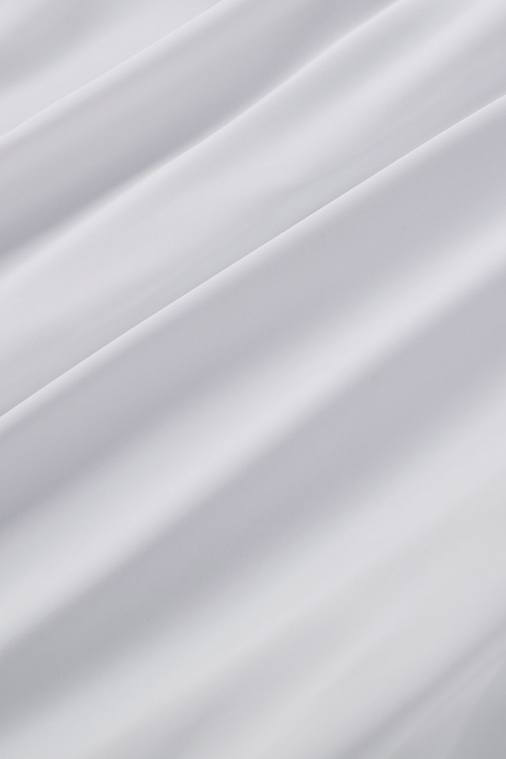 Chemisier boutonné à manches bouffantes de couleur unie