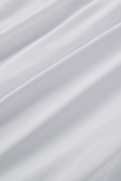 Chemisier boutonné à manches bouffantes de couleur unie