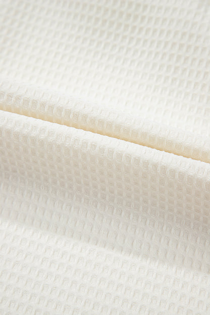 Chemisier blanc uni en tricot gaufré à volants