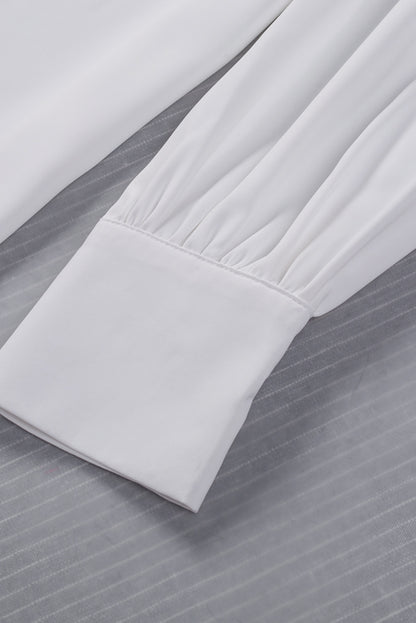 Chemisier boutonné à manches bouffantes de couleur unie