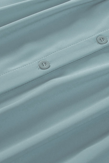 Chemisier boutonné à manches bouffantes de couleur unie