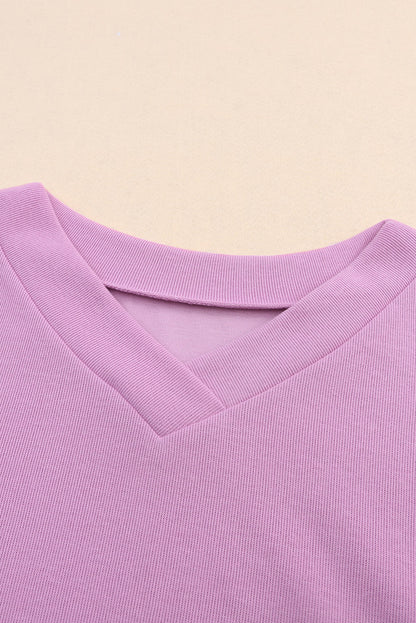 Pull violet en tricot à col en V et poignets boutonnés