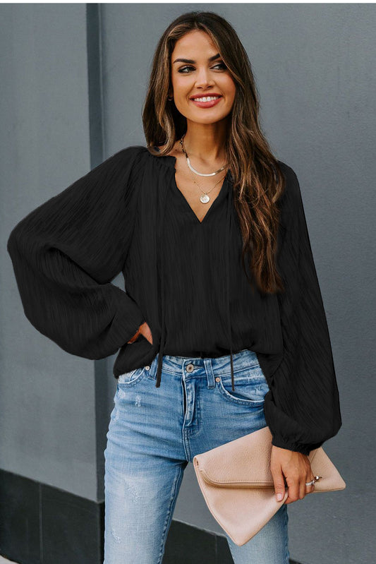 Top sólido texturizado con manga farol y cuello en V