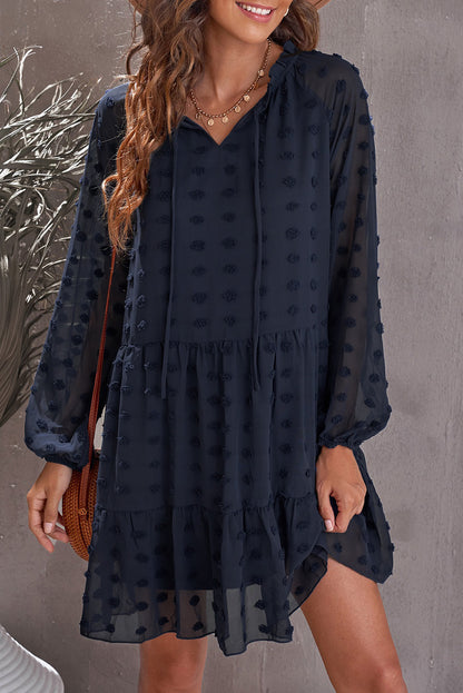 Mini-robe bleu foncé à manches longues bouffantes en maille à pois suisses