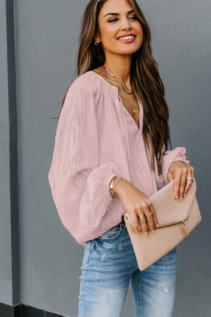 Haut uni texturé à col en V et manches lanternes 