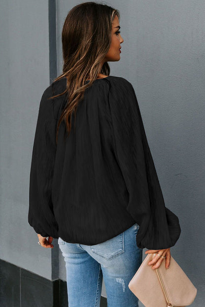 Haut uni texturé à col en V et manches lanternes 