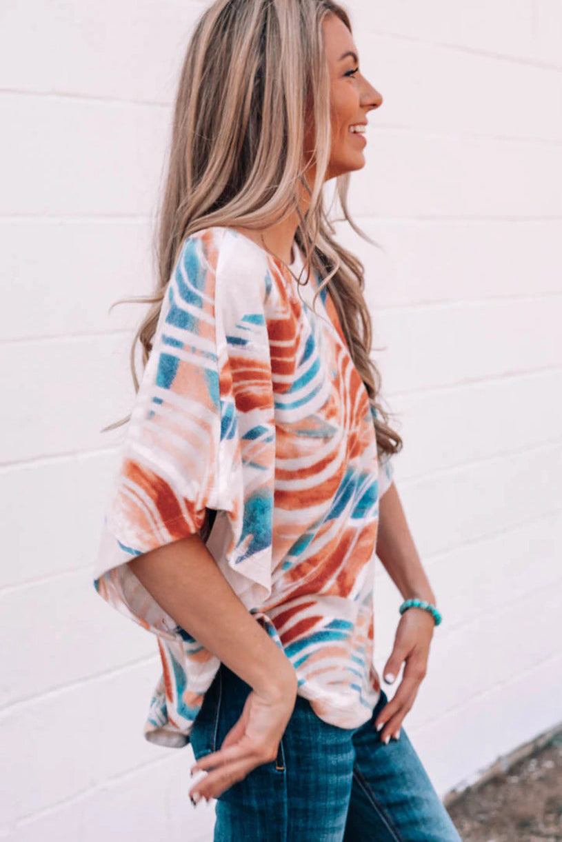 Top dolman fluido con estampado tie-dye